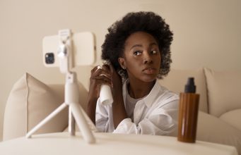 How to Get Paid on Instagram with 1000 Followers: Ultimate Guide front-view-woman-styling-hair