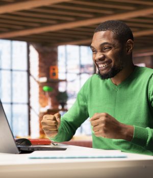 Where Nigerians Are Earning Money Online Using AI Tools (And How You Can Too) joyful-man-home-happily-shaking-fists-ecstatic-1-scaled