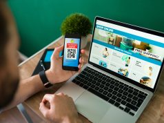 How to Start an Ecommerce Business Without Capital young-man-using-discount-coupon-his-smartphone-some-online-shopping-laptop-scaled